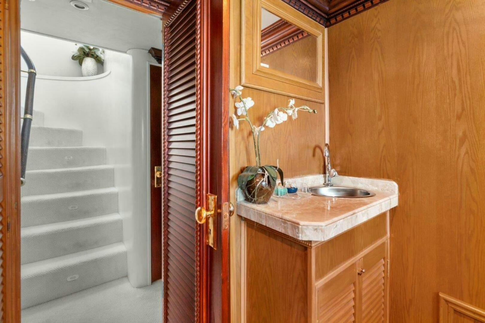 a bathroom with a sink and a door aboard ENVISION Yacht for Sale