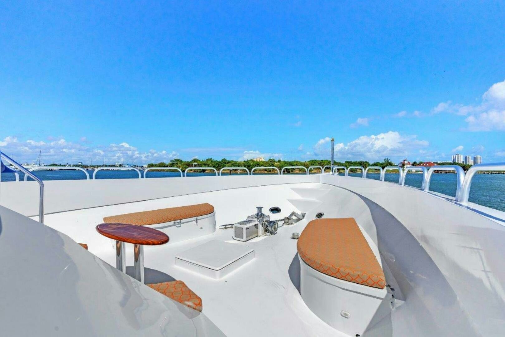 a lounge chair on a balcony overlooking a beach aboard ENVISION Yacht for Sale