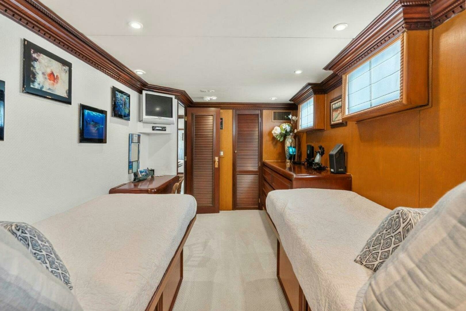 a bedroom with a bed and a tv aboard ENVISION Yacht for Sale