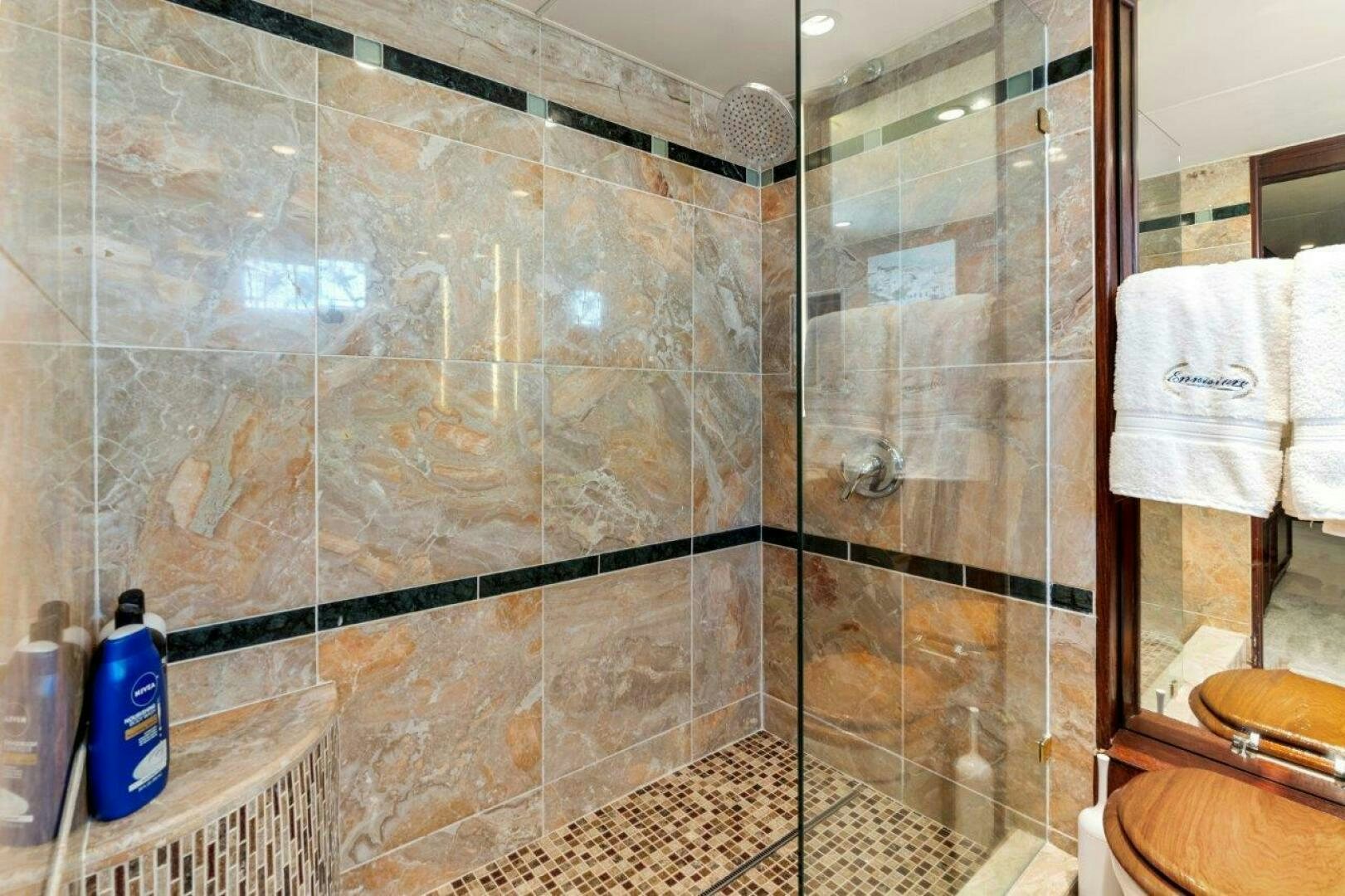 a bathroom with a glass shower aboard ENVISION Yacht for Sale