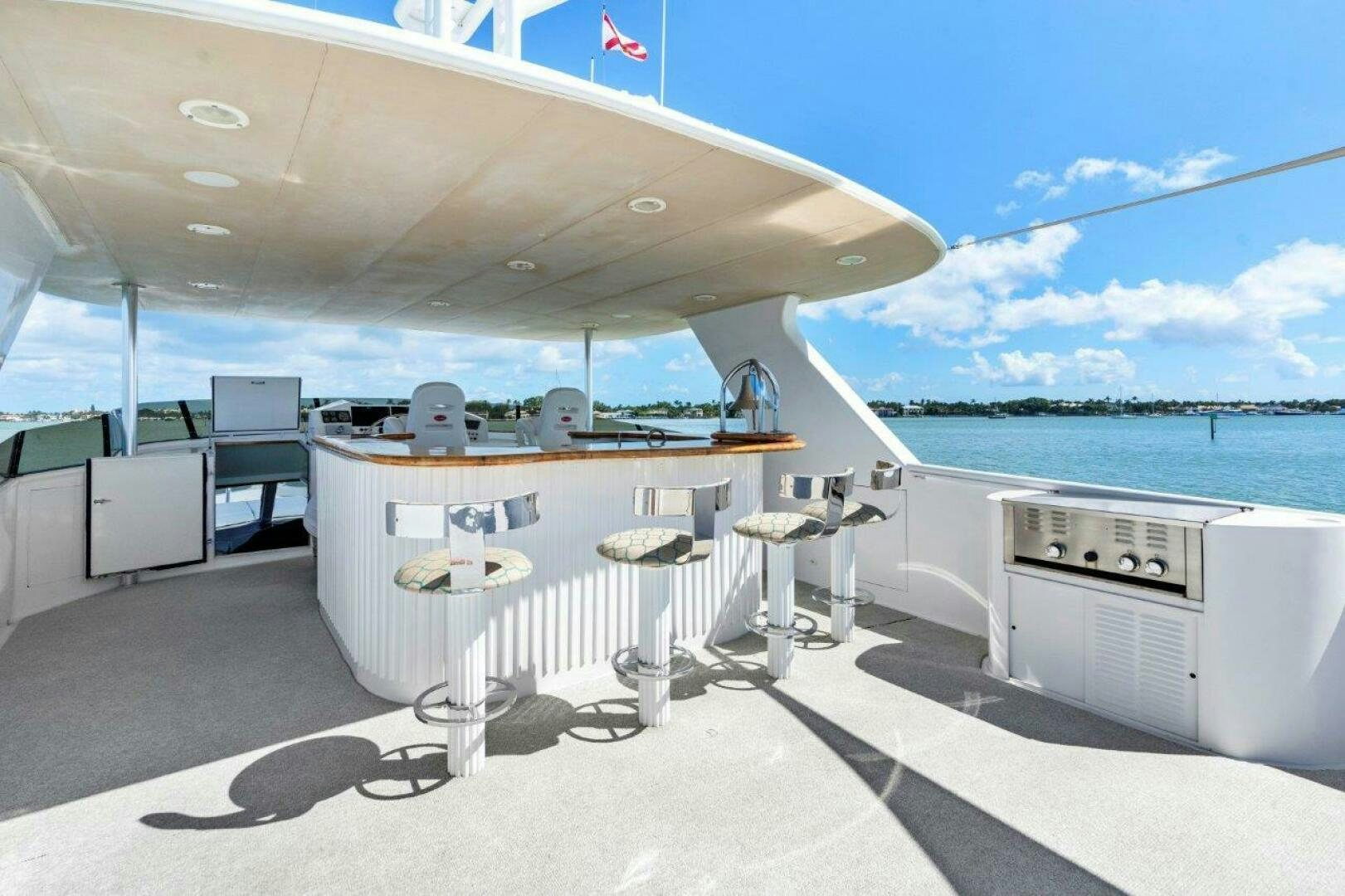 a large white boat with a desk and chairs on it aboard ENVISION Yacht for Sale