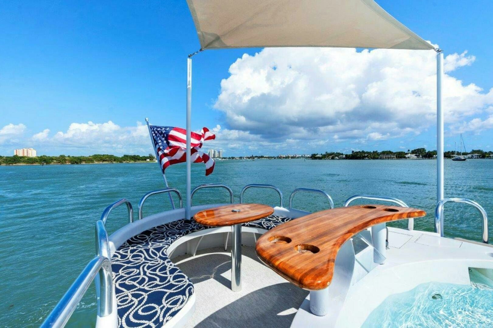 a boat with a flag on the front aboard ENVISION Yacht for Sale