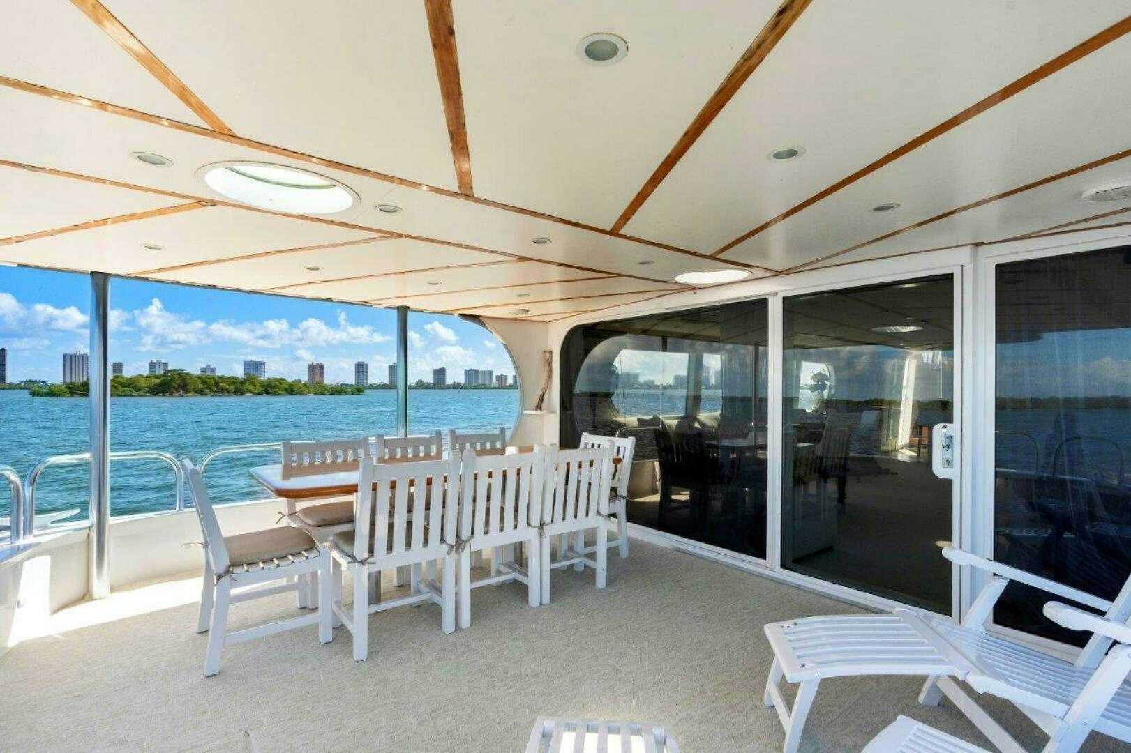 a room with a table chairs and a large body of water aboard ENVISION Yacht for Sale