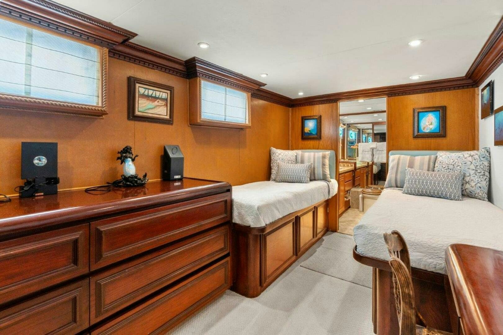 a bedroom with a bed and a desk aboard ENVISION Yacht for Sale