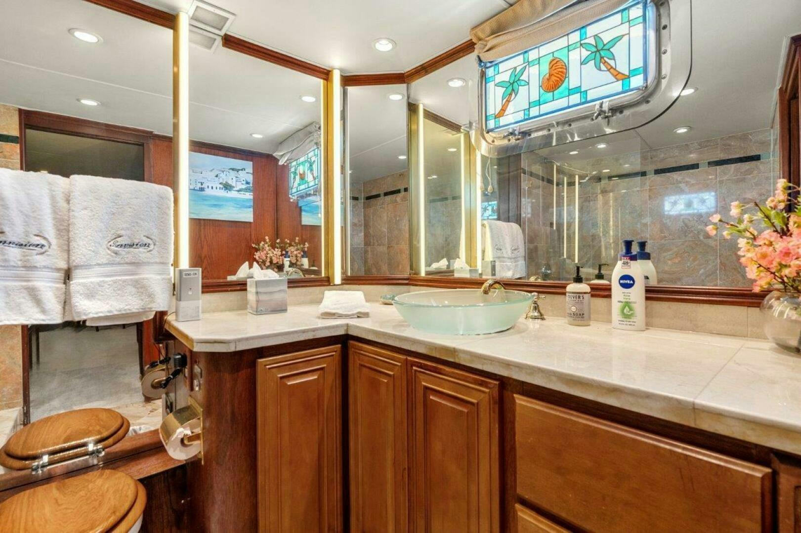 a bathroom with a large mirror aboard ENVISION Yacht for Sale