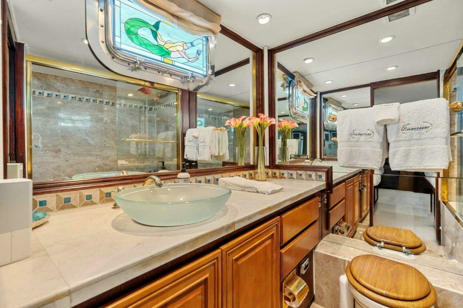 a bathroom with a large mirror aboard ENVISION Yacht for Sale