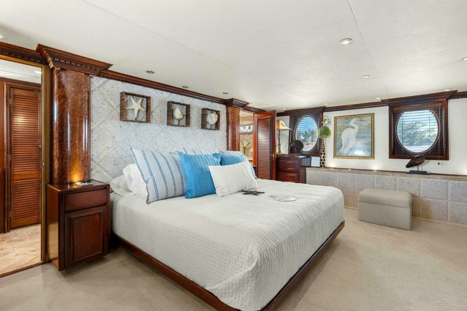a bedroom with a bed and a mirror aboard ENVISION Yacht for Sale
