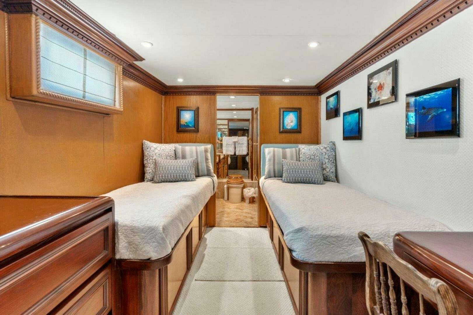 a room with a bed and a table aboard ENVISION Yacht for Sale