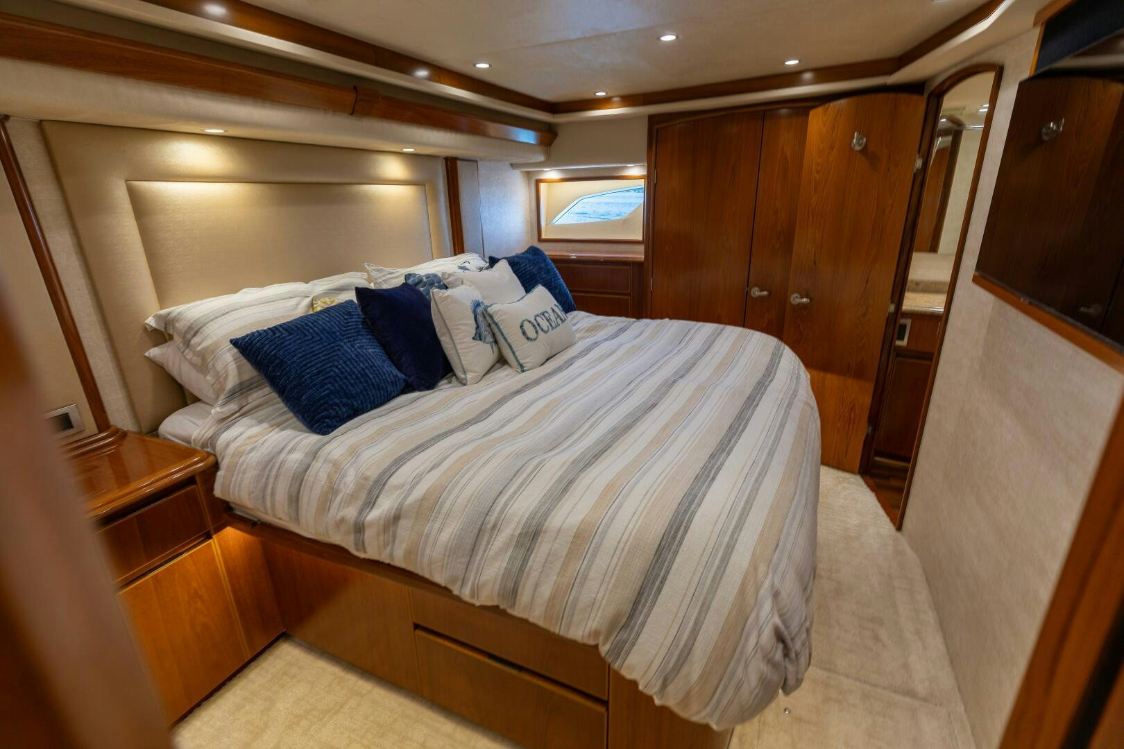 a bed with blue and white pillows aboard SMOOTH RIDE Yacht for Sale