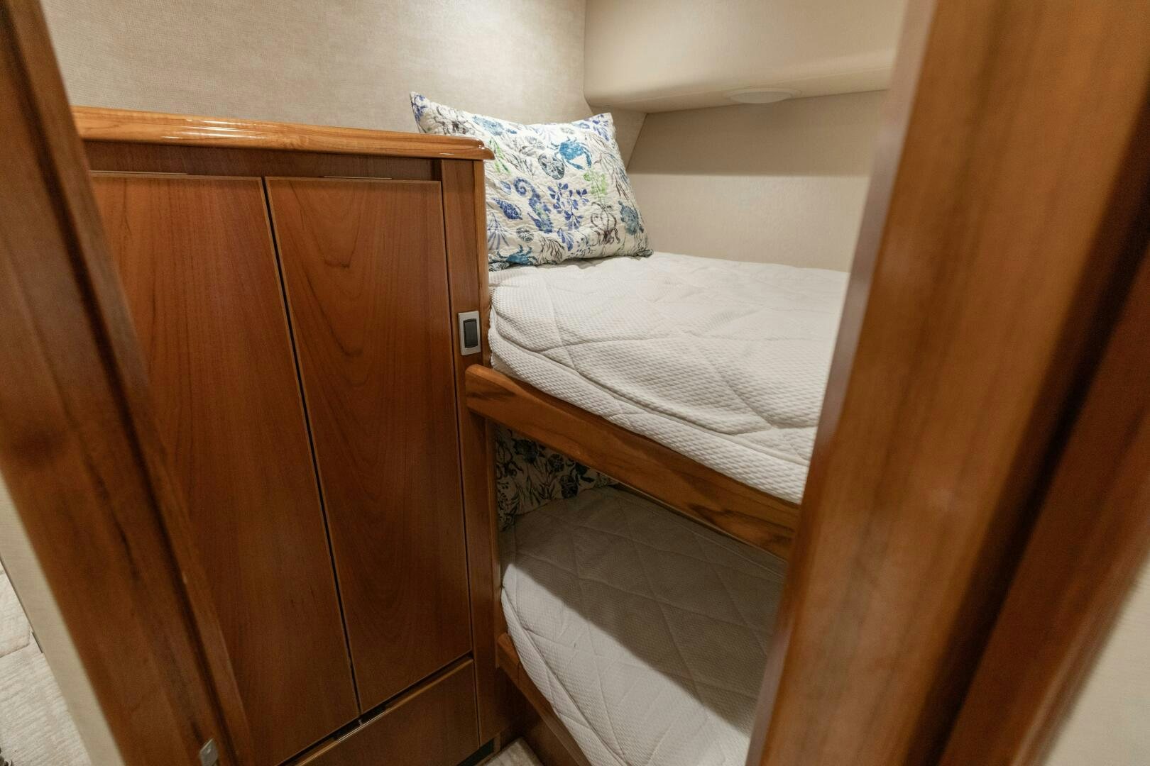 a bed with a wooden headboard aboard SMOOTH RIDE Yacht for Sale