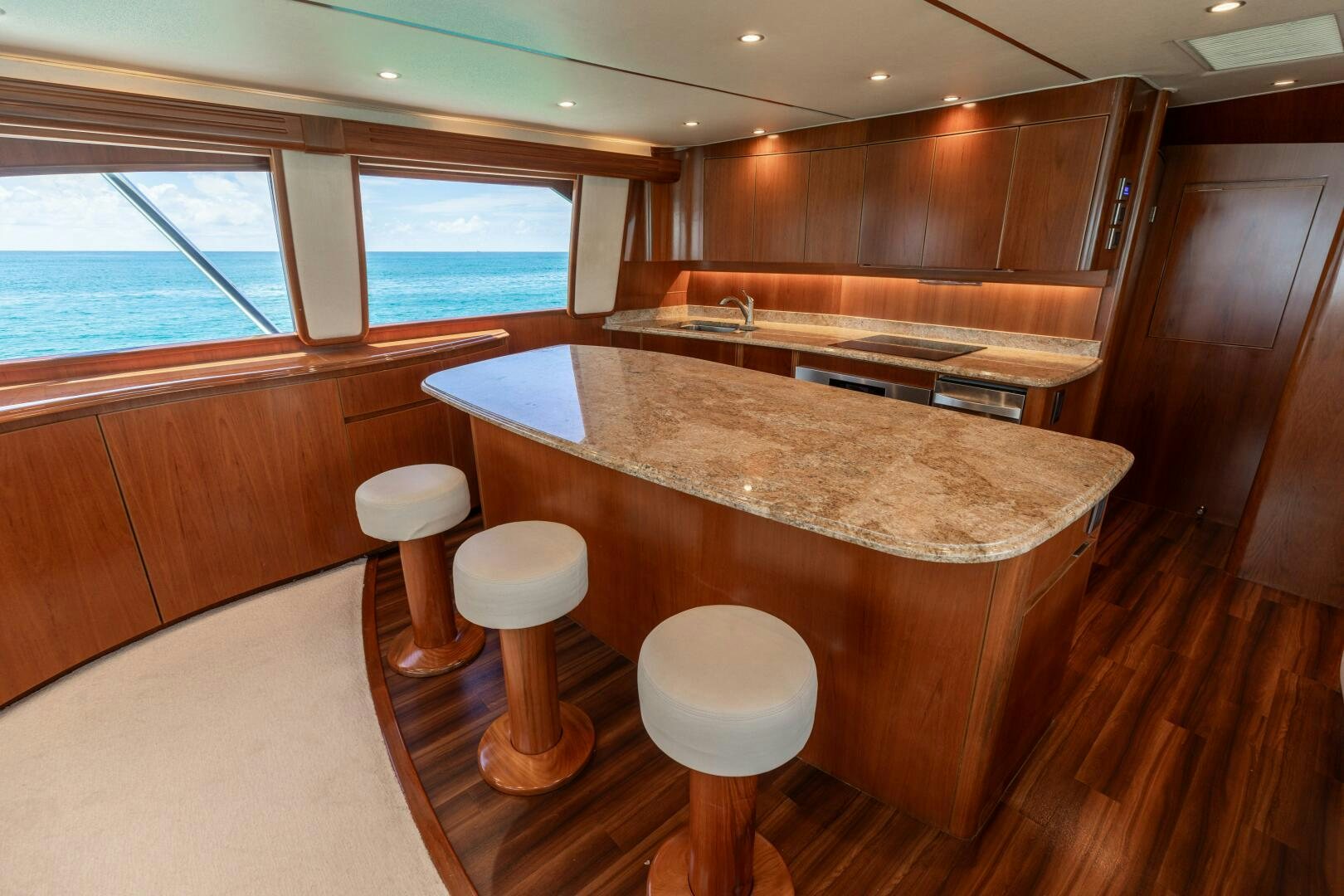 a large kitchen with a bar and stools aboard SMOOTH RIDE Yacht for Sale