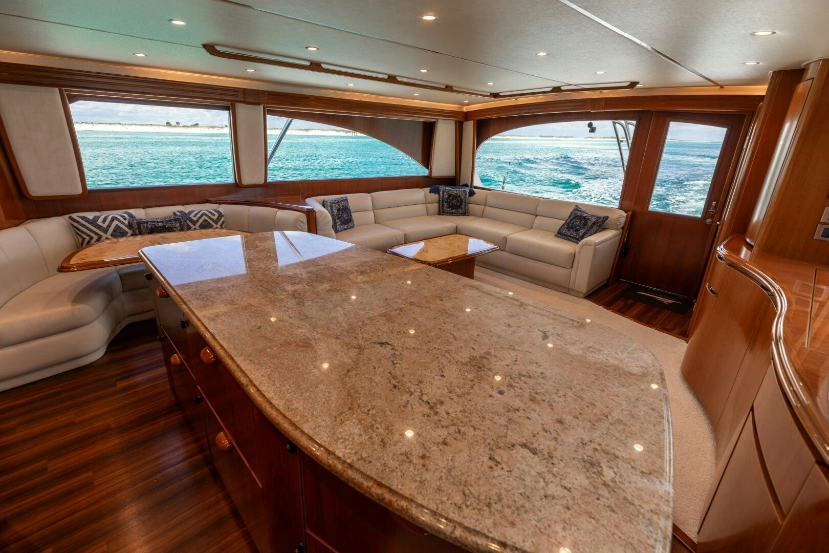 a large living room with a large table and chairs aboard SMOOTH RIDE Yacht for Sale