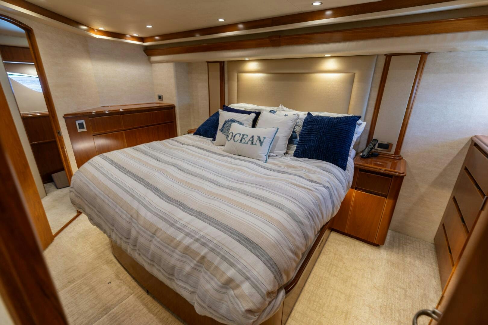 a bed with blue and white pillows aboard SMOOTH RIDE Yacht for Sale