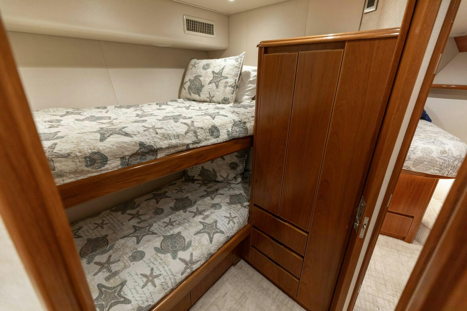a bed with a wooden headboard aboard SMOOTH RIDE Yacht for Sale