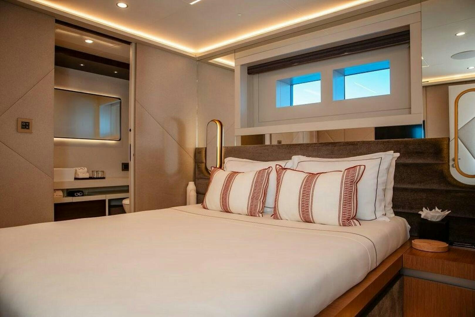 a bed with a white bed spread aboard INFINITY NINE Yacht for Sale