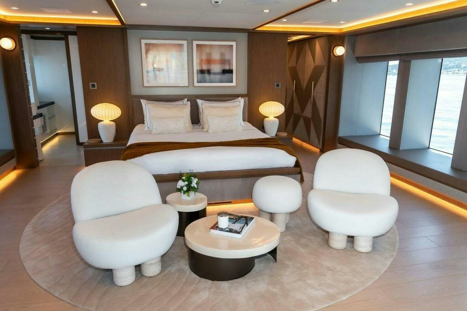 a large hotel room with a large bed and a table aboard INFINITY NINE Yacht for Sale