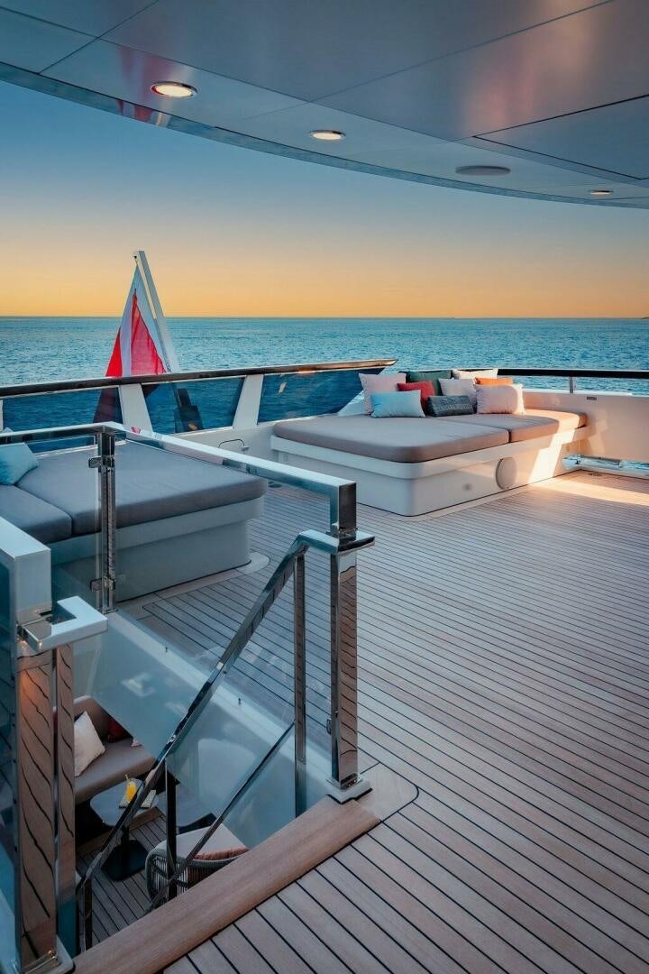 a deck with a large body of water and a beach aboard INFINITY NINE Yacht for Sale