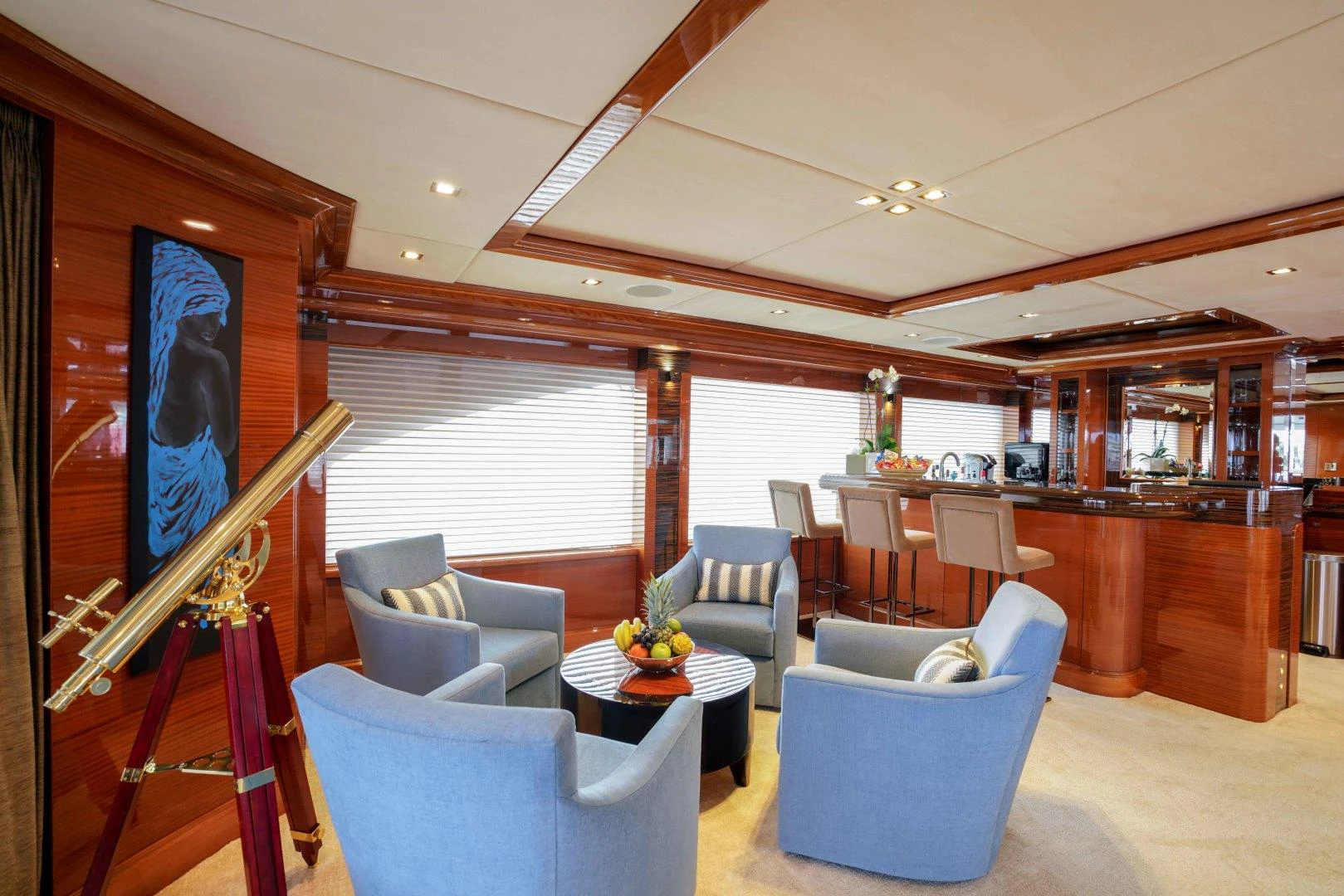 a living room with a staircase and blue chairs aboard ASPEN ALTERNATIVE Yacht for Charter