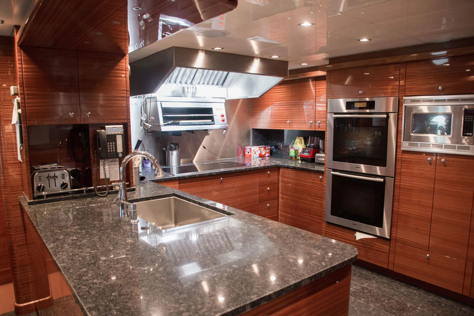 a kitchen with wooden cabinets aboard ASPEN ALTERNATIVE Yacht for Charter
