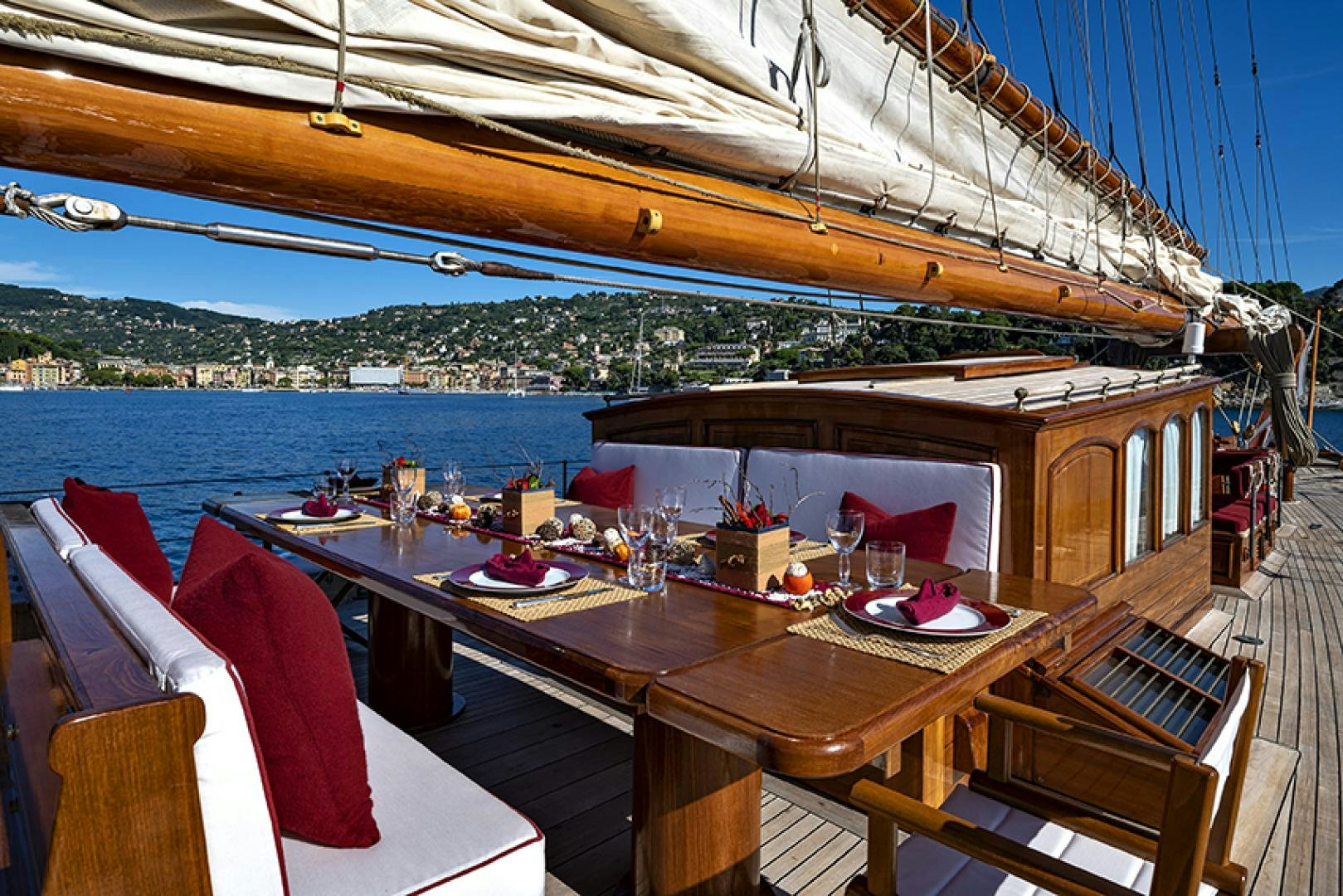 a table with a view of the ocean and a city aboard INVADER Yacht for Charter