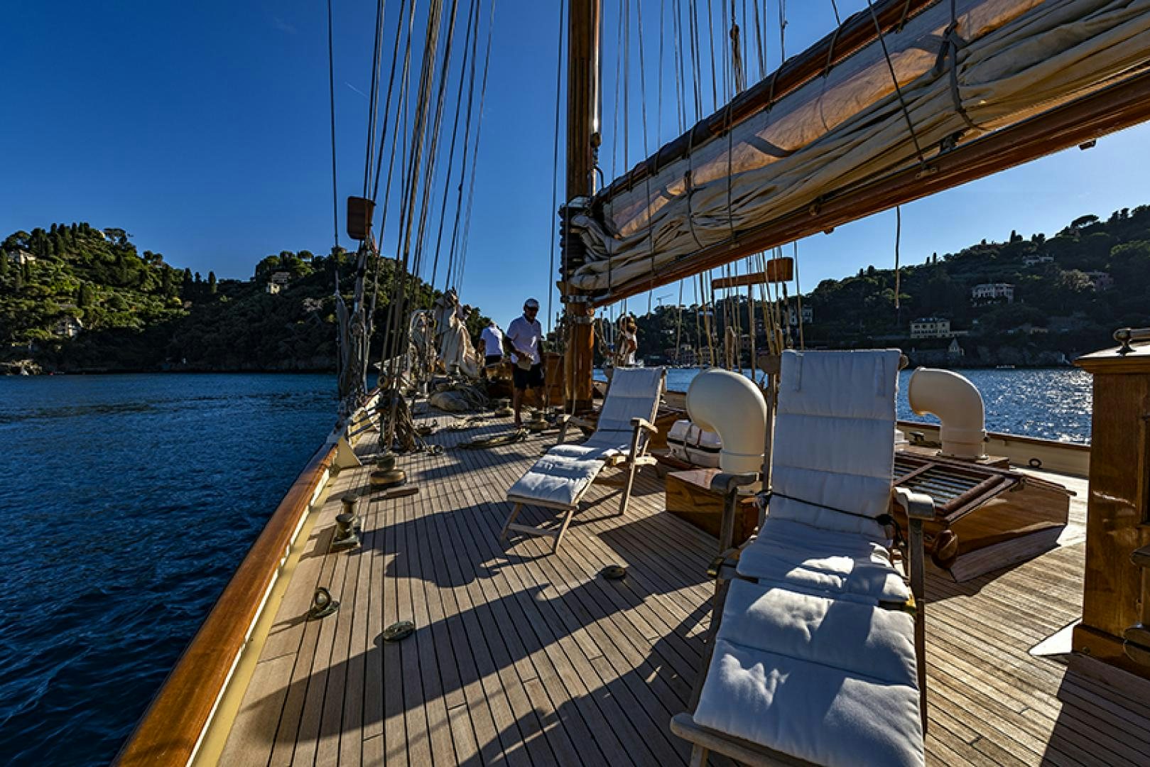 a deck with chairs and a body of water aboard INVADER Yacht for Charter
