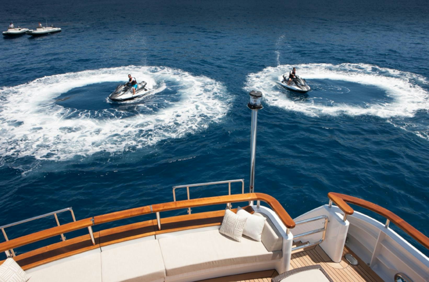 a couple of people riding surfboards aboard MIRAGE Yacht for Charter