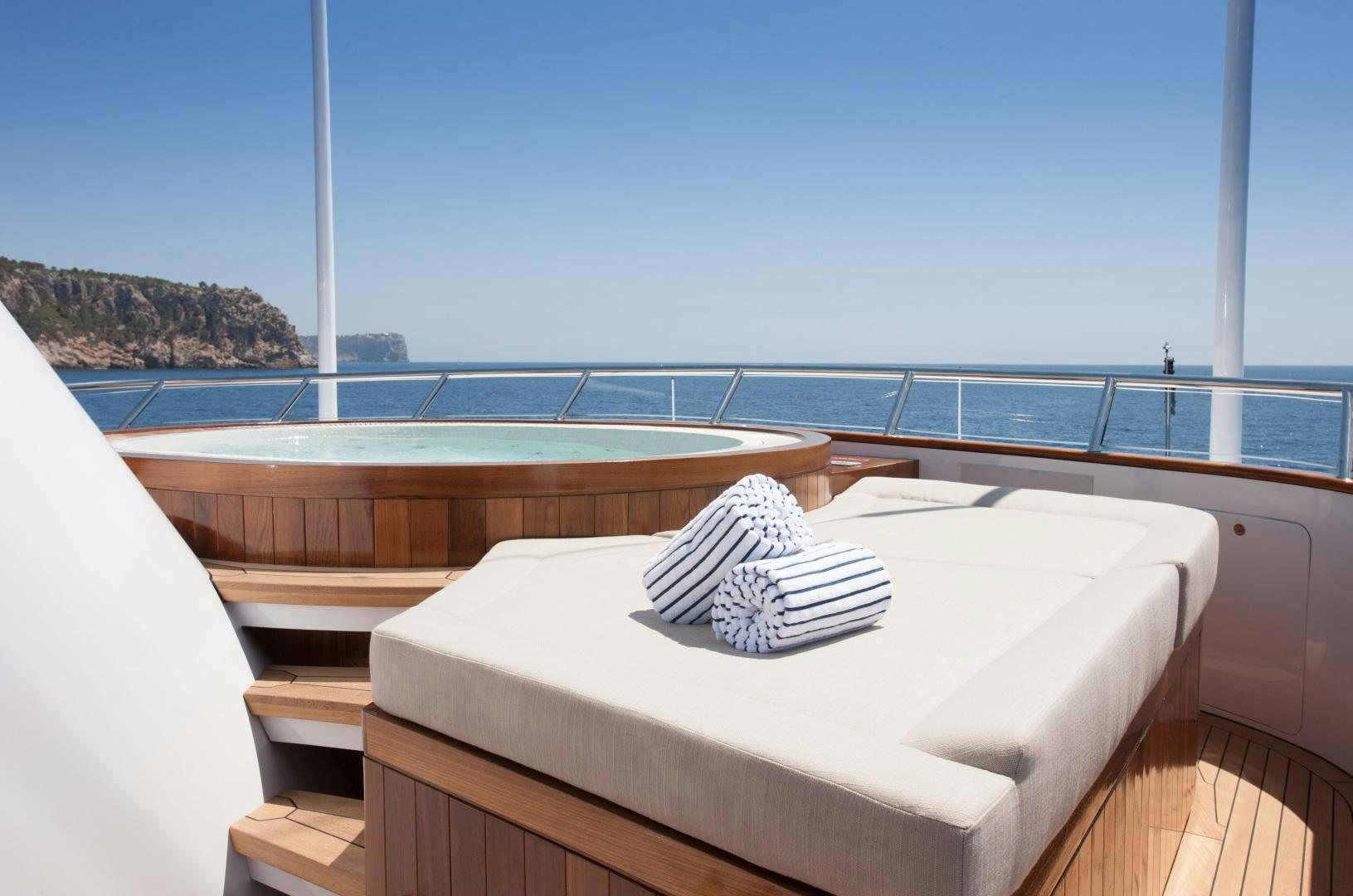 a bed on a balcony aboard MIRAGE Yacht for Charter