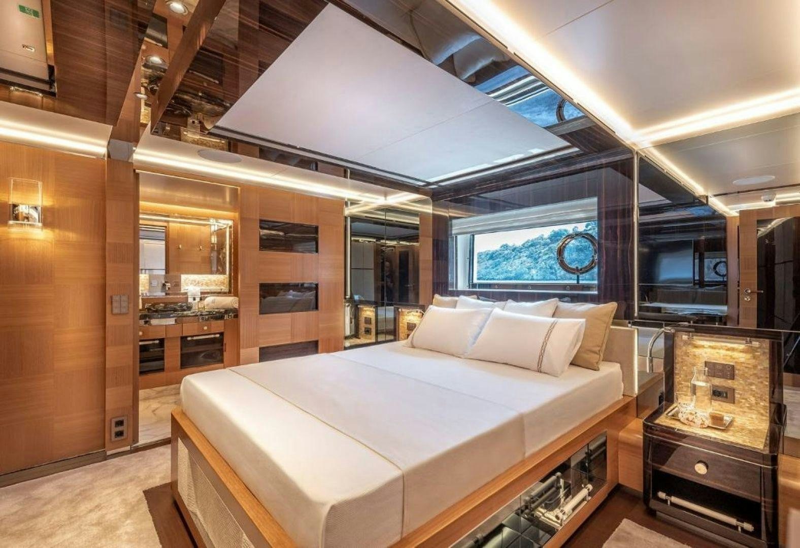 a room with a bed and a large window aboard SUNRISE Yacht for Charter