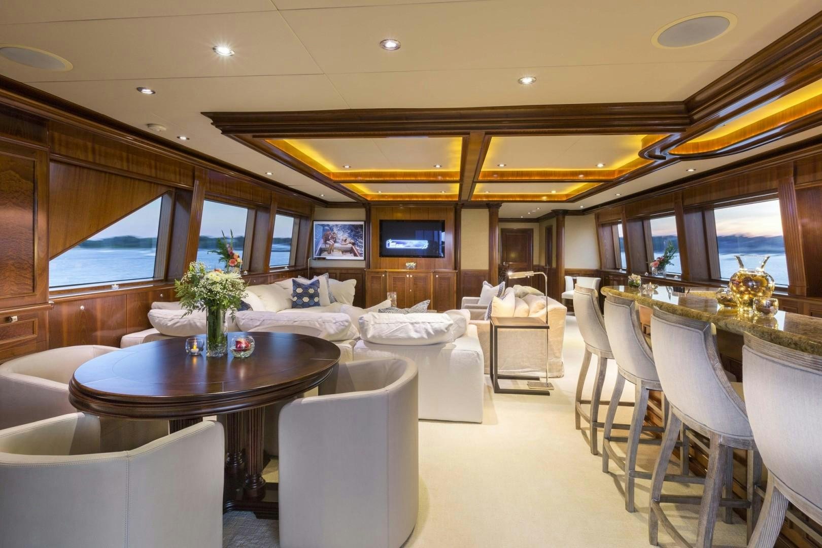 a large living room with a large window aboard FAR FROM IT Yacht for Charter