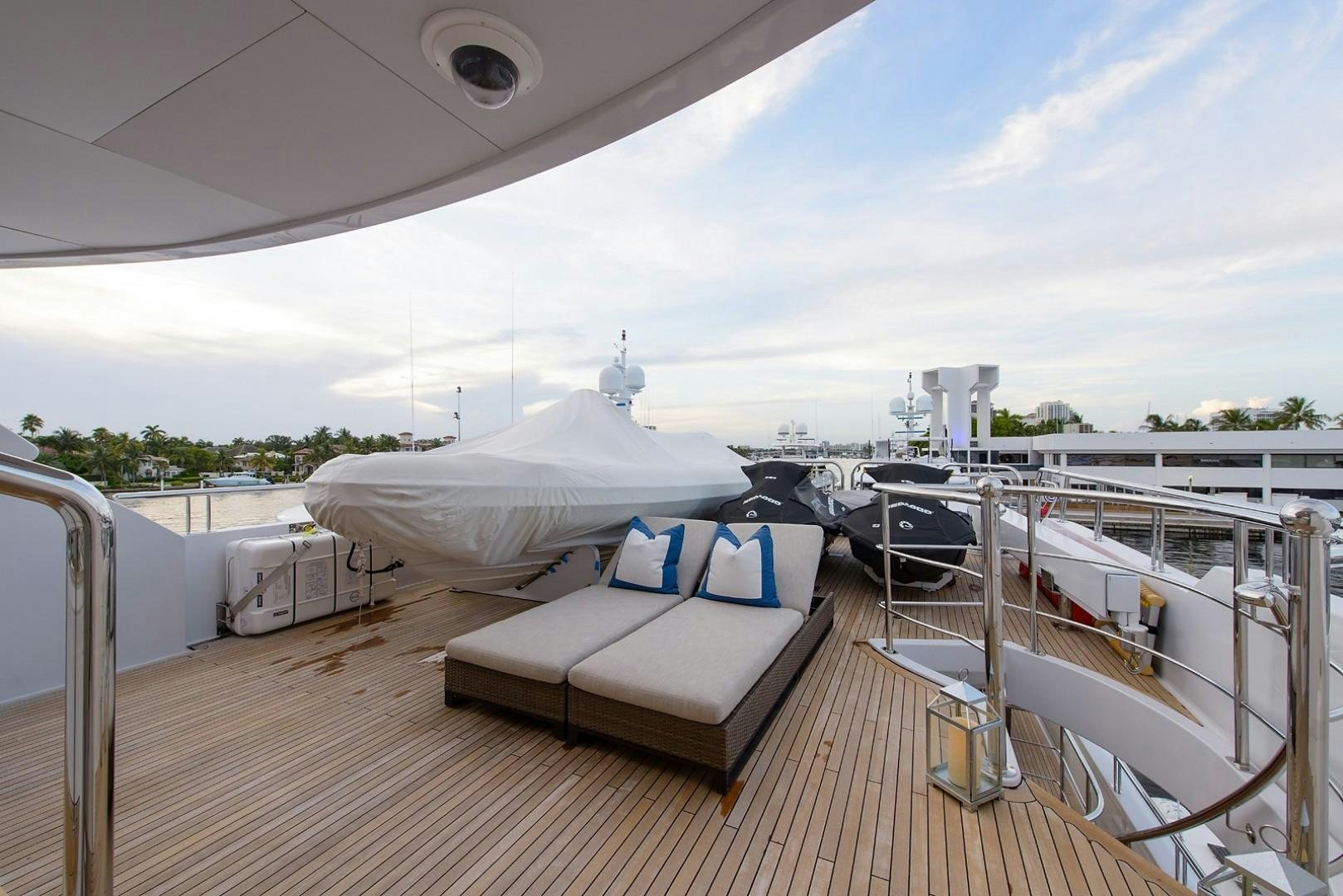 a deck with a view of a city and a large body of water aboard FAR FROM IT Yacht for Charter
