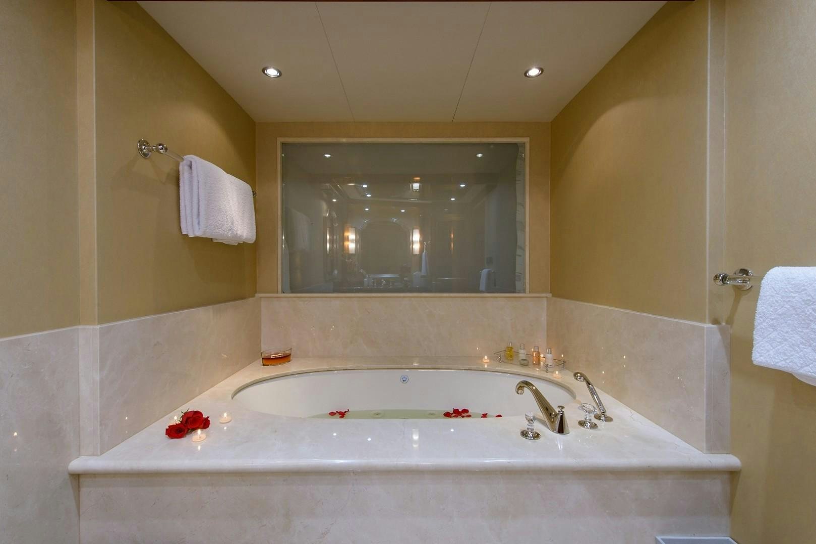 a bathroom with a large bathtub aboard FAR FROM IT Yacht for Charter