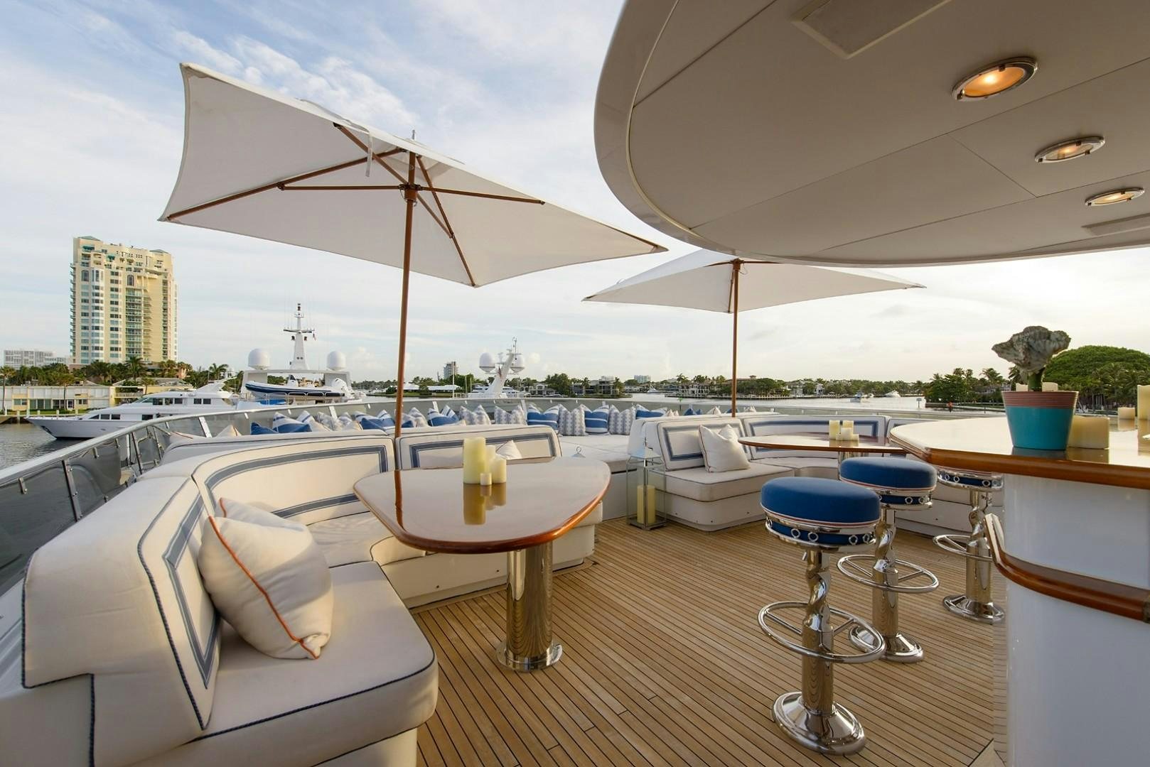 a lounge area with a large umbrella aboard FAR FROM IT Yacht for Charter