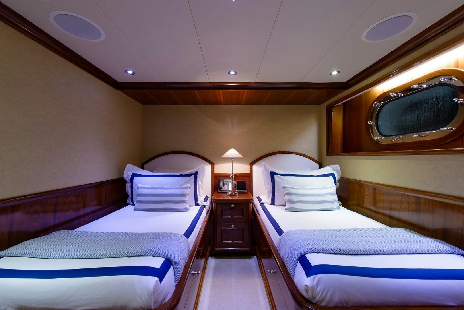 a couple of beds in a hotel room aboard FAR FROM IT Yacht for Charter