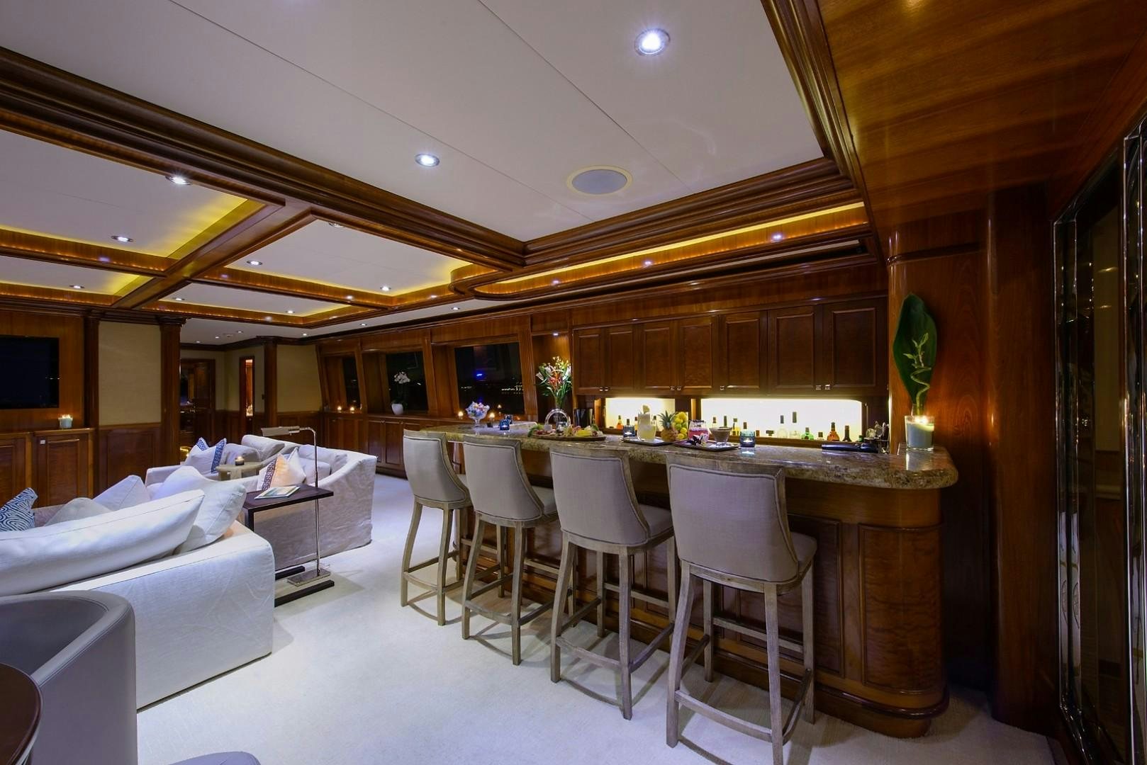 a room with a table and chairs aboard FAR FROM IT Yacht for Charter