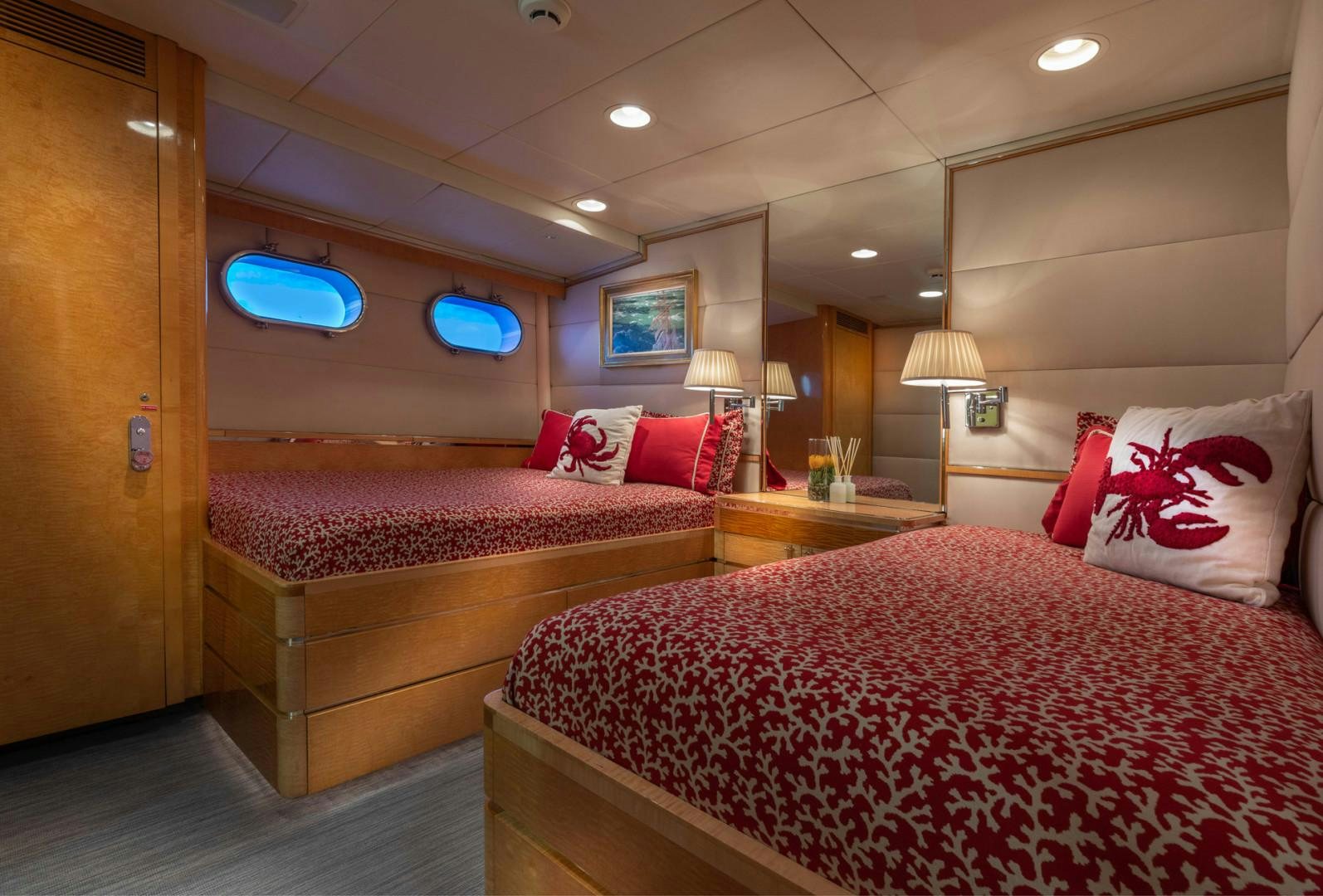 a hotel room with two beds aboard RENA Yacht for Charter