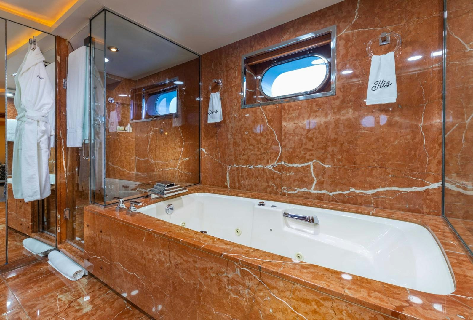 a bathroom with a bathtub and a window aboard RENA Yacht for Charter