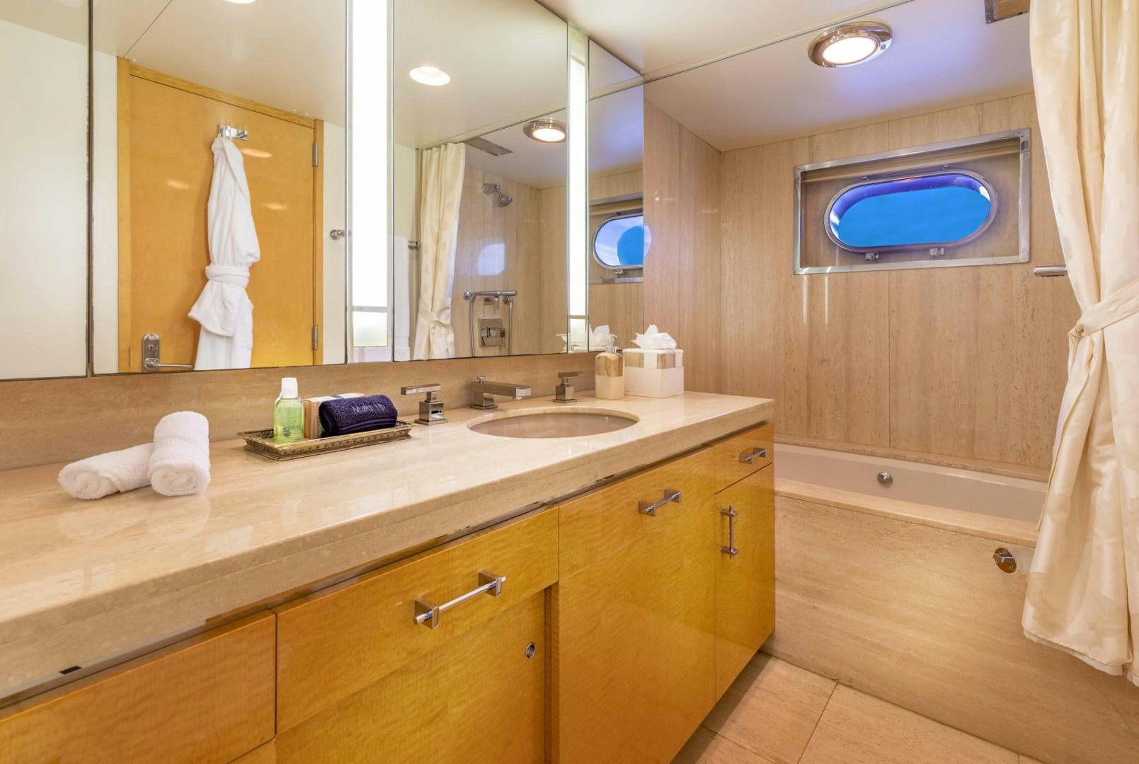 a bathroom with a large mirror aboard RENA Yacht for Charter