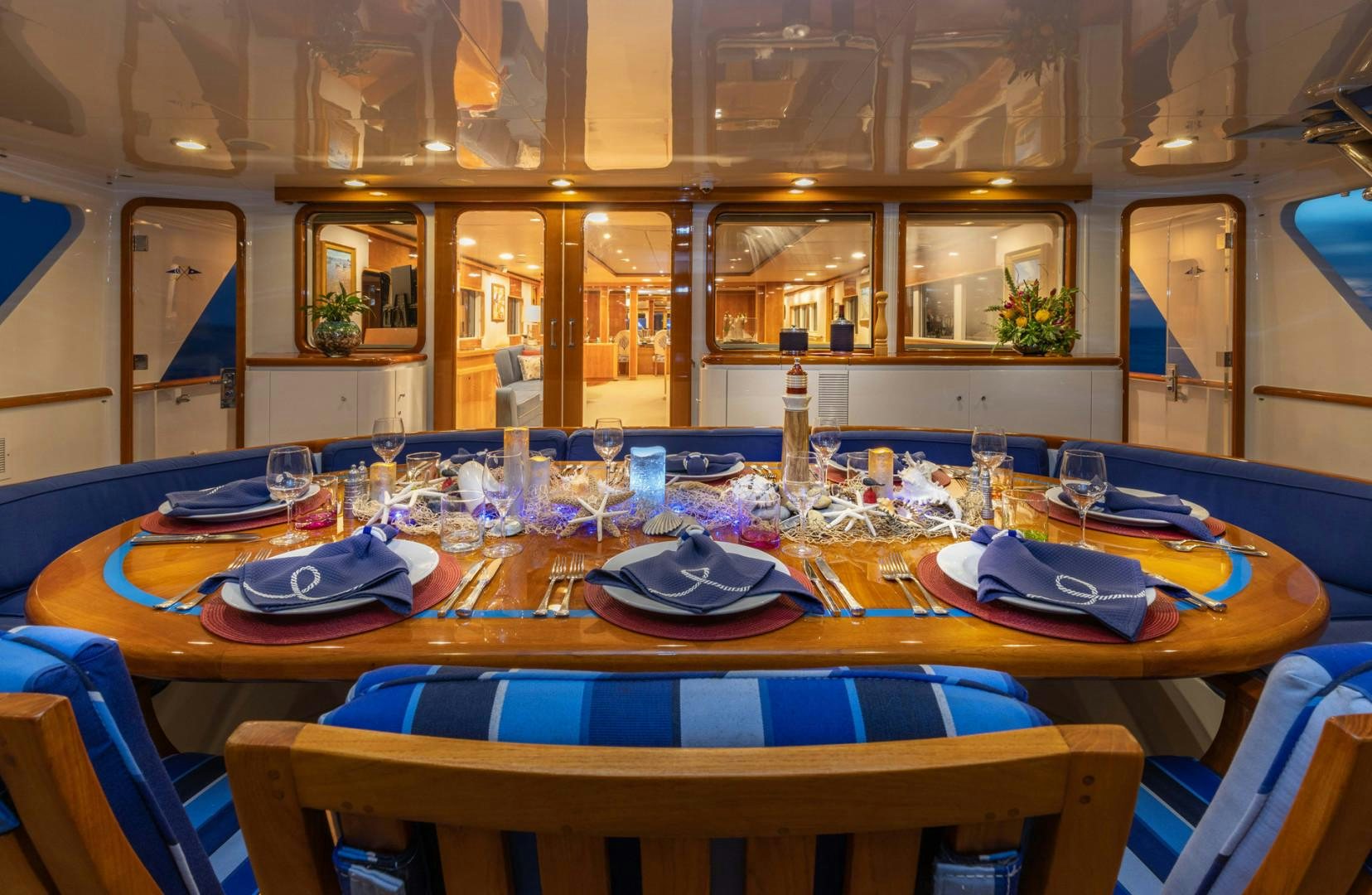 a table set with plates and glasses aboard RENA Yacht for Charter