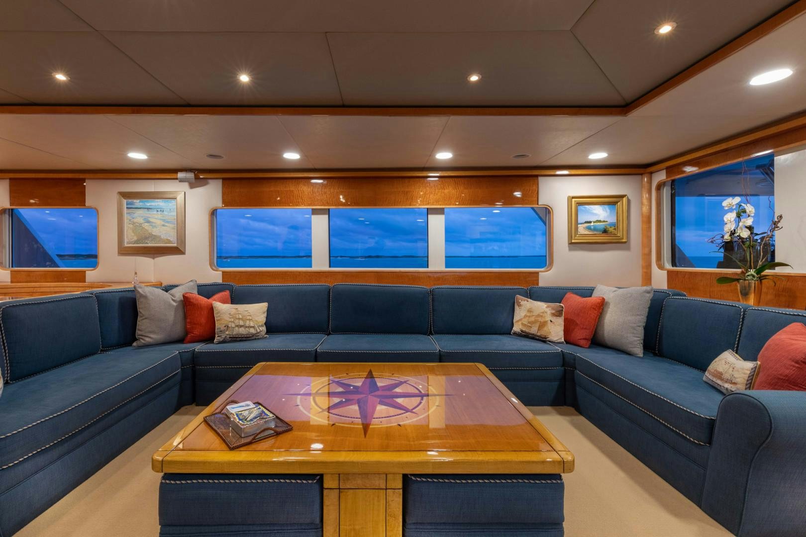 a living room with a blue couch aboard RENA Yacht for Charter