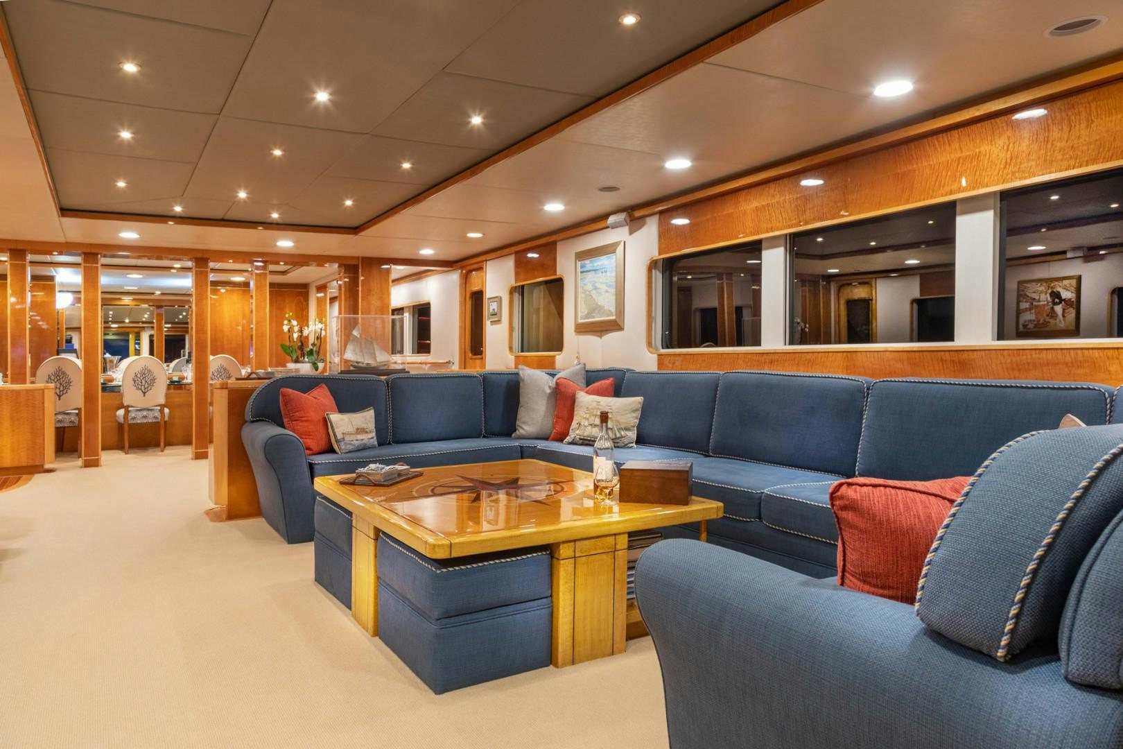 a living room with a blue couch and a coffee table aboard RENA Yacht for Charter