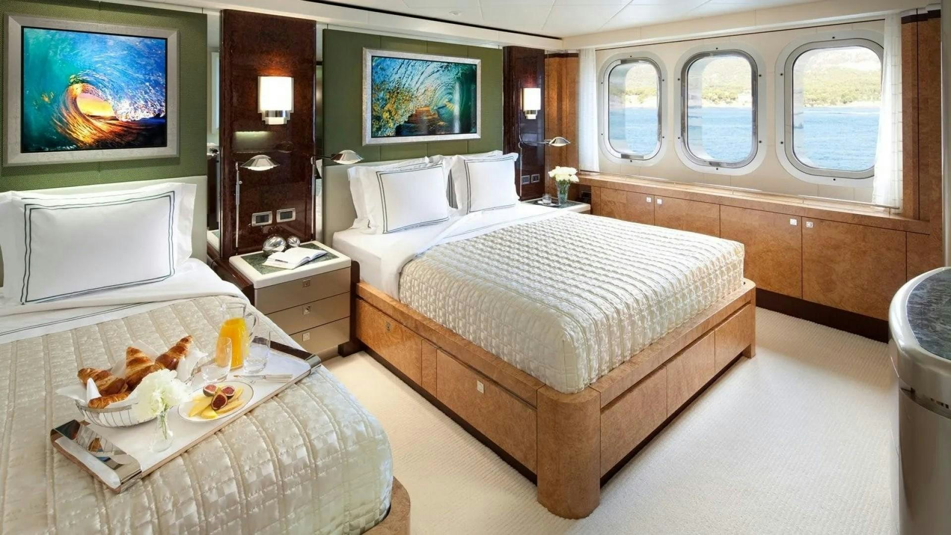 a bedroom with two beds aboard SYCARA V Yacht for Charter