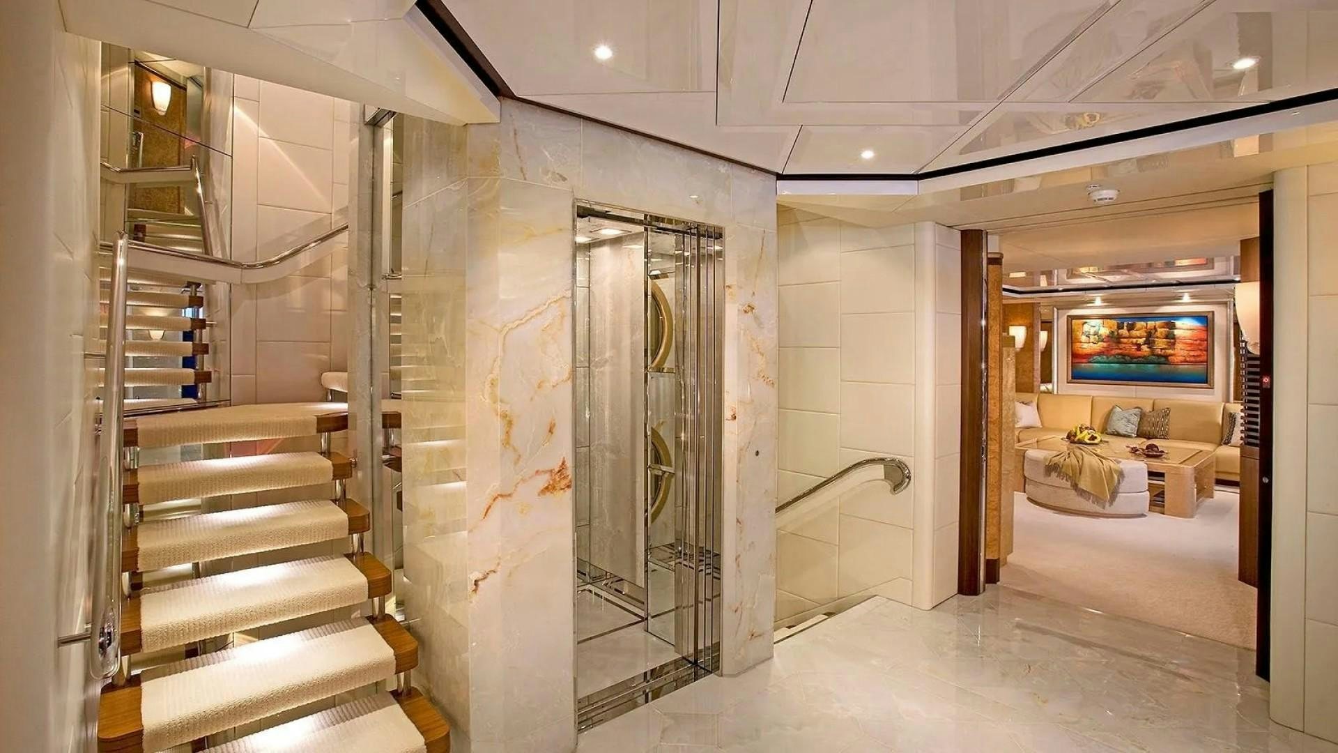 a room with a staircase and glass doors aboard SYCARA V Yacht for Charter