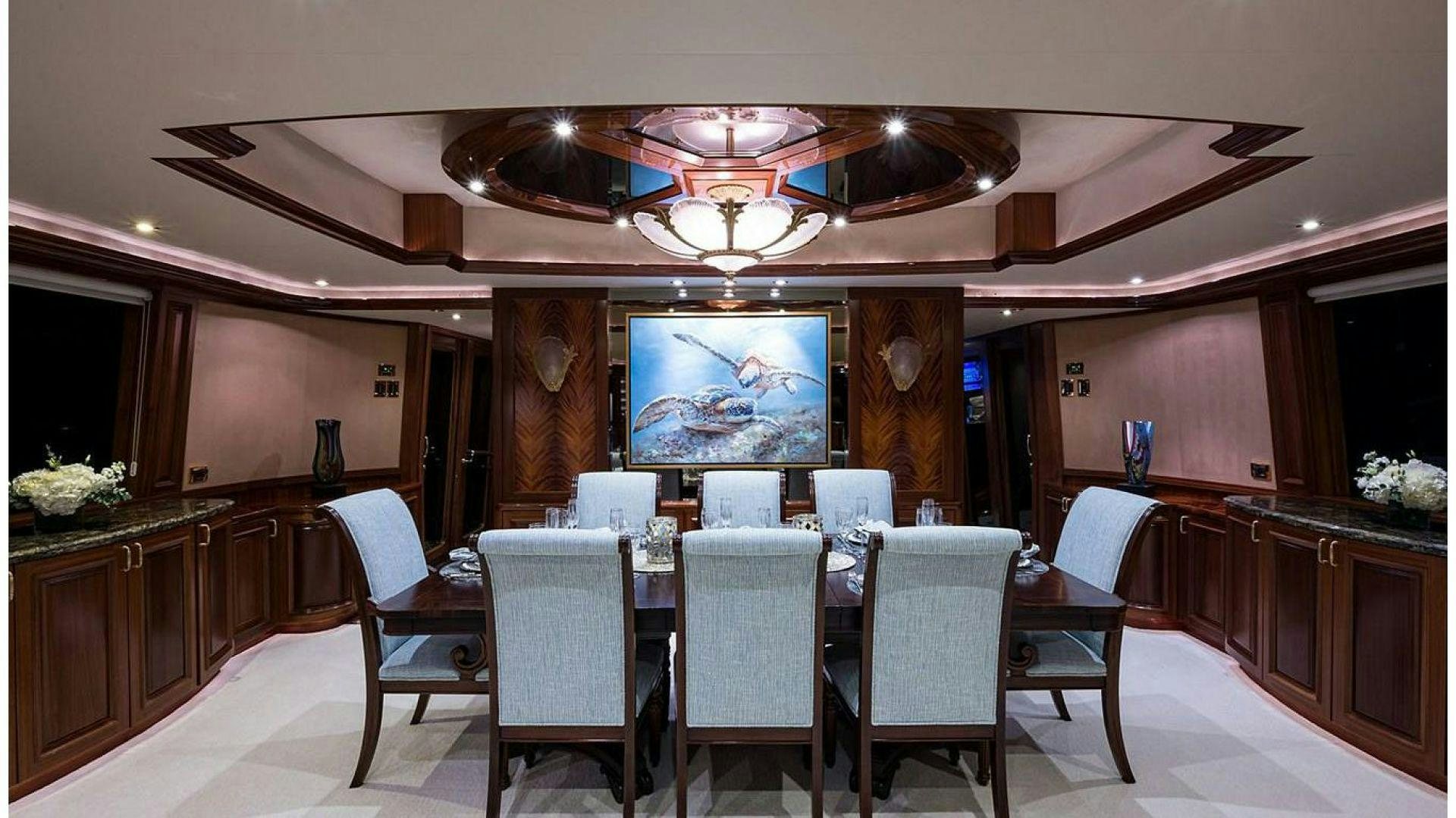 a large dining room with a table and chairs aboard NOW OR NEVER Yacht for Charter