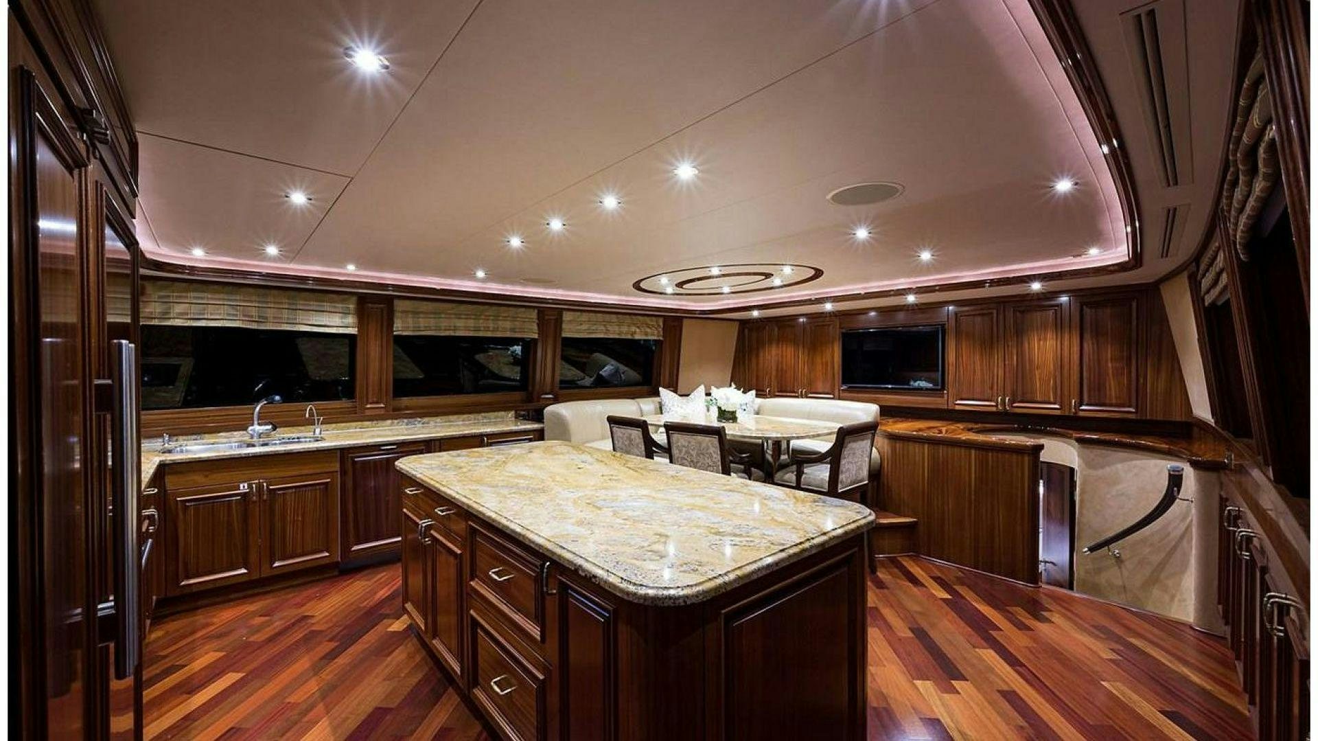 a kitchen with wooden cabinets aboard NOW OR NEVER Yacht for Charter