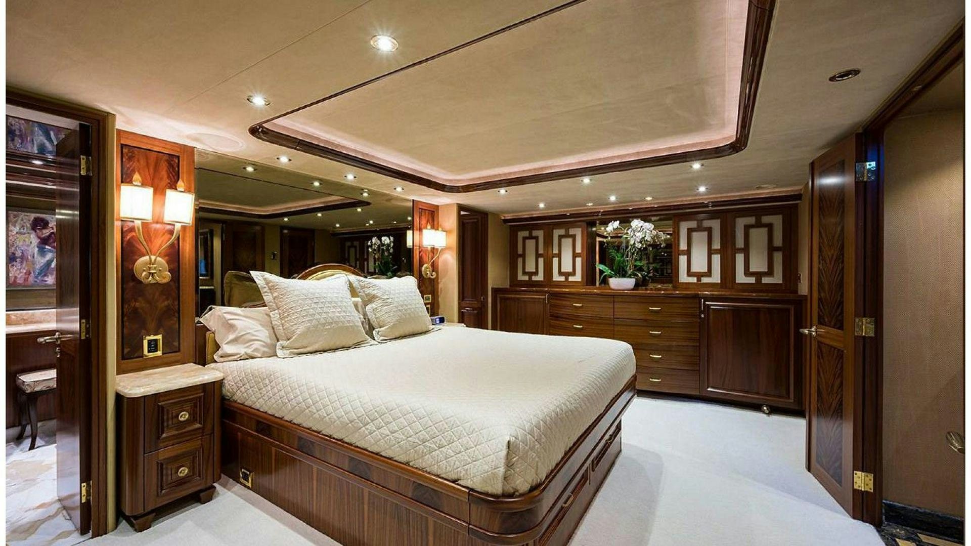 a bedroom with a bed and cabinets aboard NOW OR NEVER Yacht for Charter