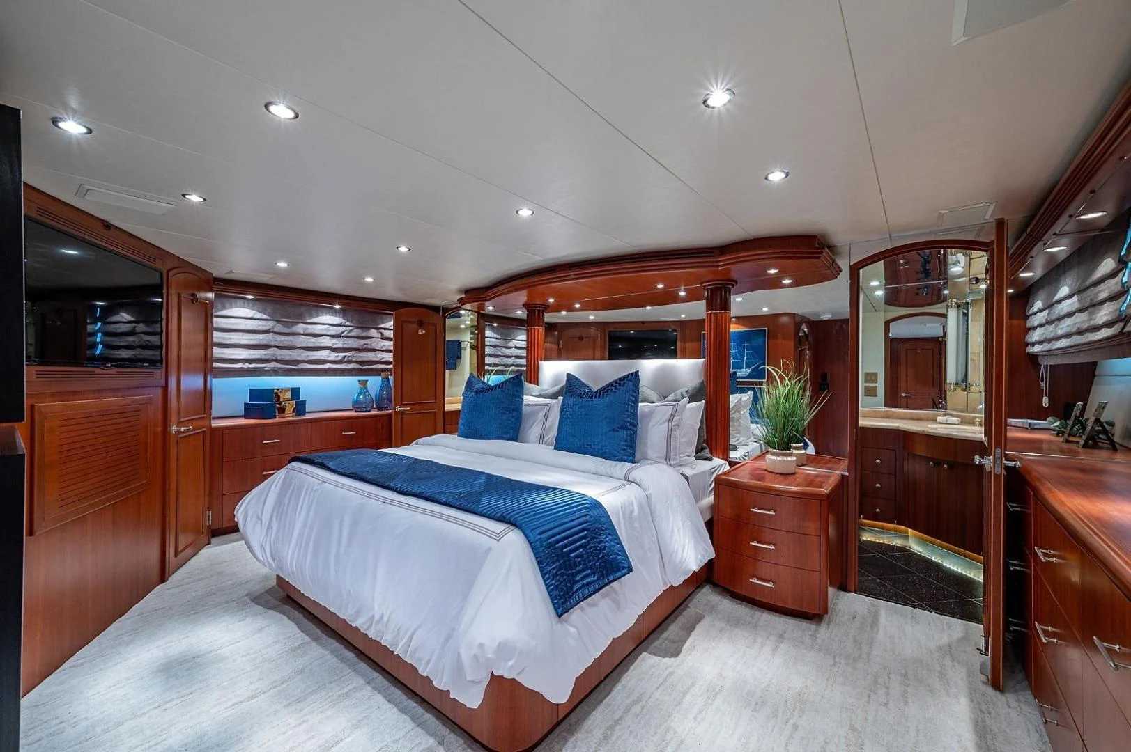 a bedroom with a bed and a mirror aboard MAGNUM RIDE Yacht for Charter