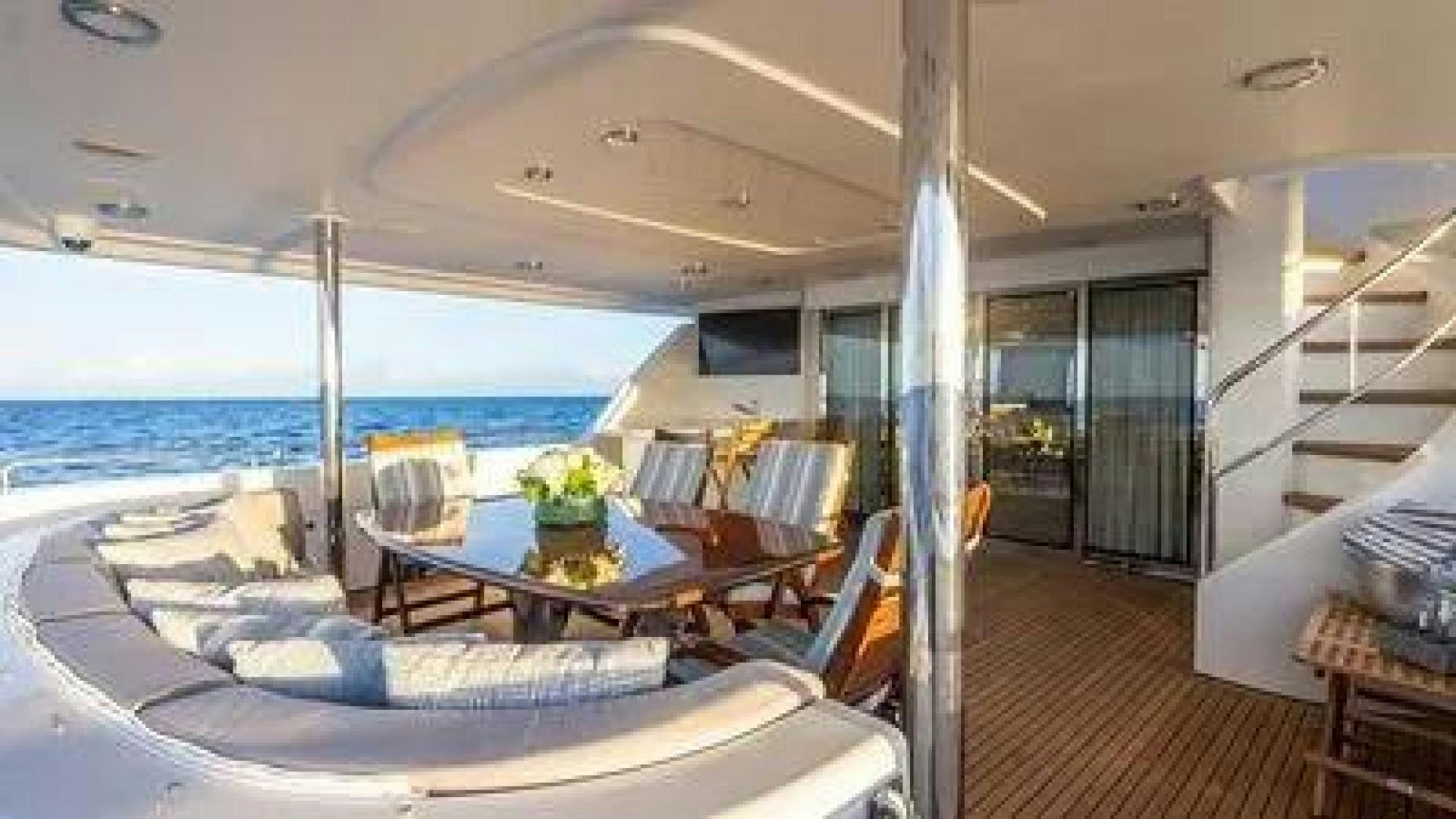 a large living room with a large balcony overlooking the ocean aboard KEMOSABE Yacht for Charter