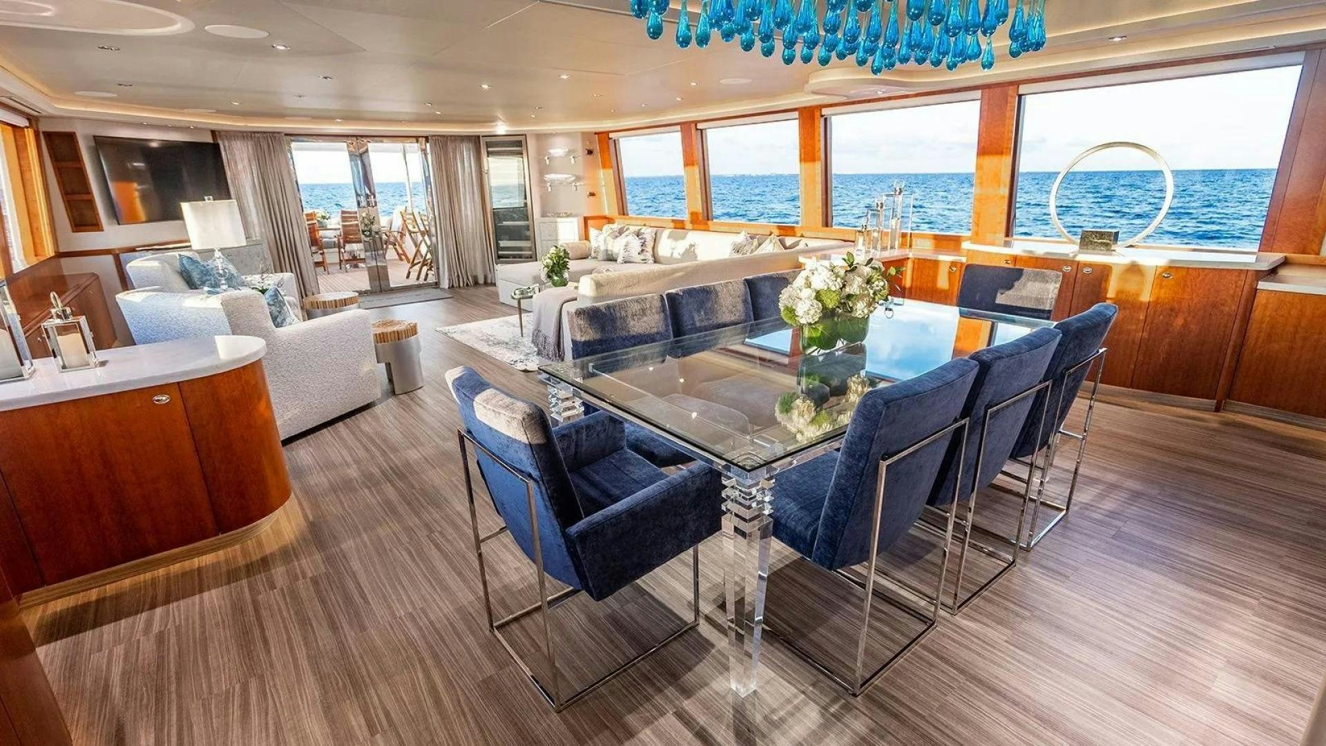 a large living room with a large table and chairs aboard KEMOSABE Yacht for Charter