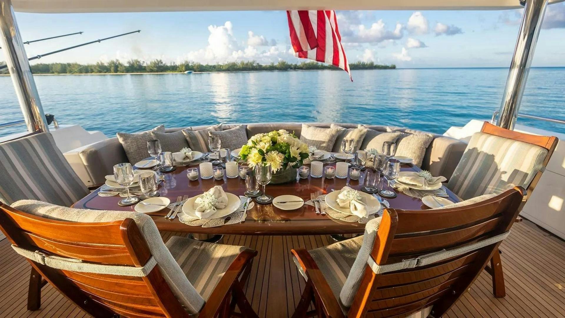 a table set for a dinner on a boat aboard KEMOSABE Yacht for Charter