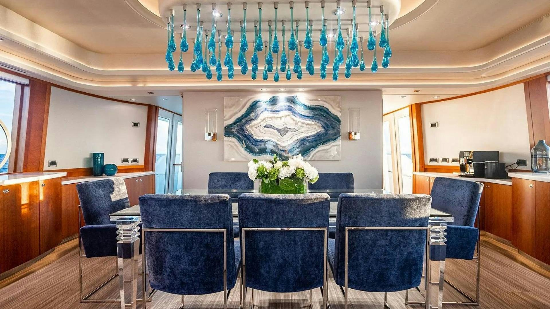a room with chairs and tables aboard KEMOSABE Yacht for Charter